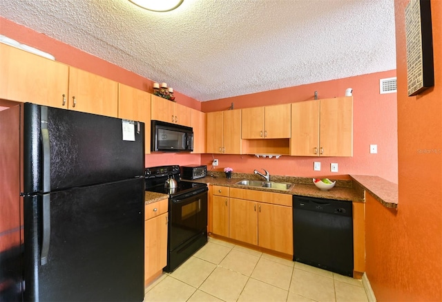 4015 My Lady Ln Unit 7, Land O Lakes, FL 34638 - kitchen with black appliances, a textured ceiling, light tile patterned floors, dark countertops, and light brown cabinetry