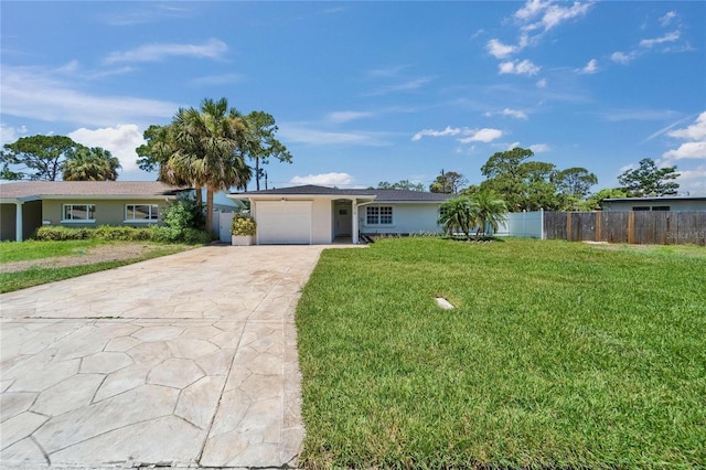 4518 Helena St NE, Saint Petersburg, FL 33703 - ranch-style house with concrete driveway, an attached garage, and stucco siding
