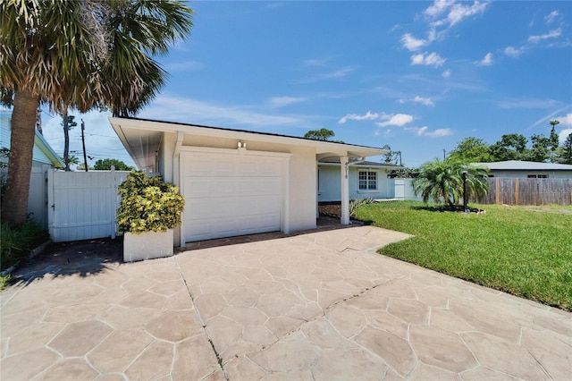 4518 Helena St NE, Saint Petersburg, FL 33703 - view of front facade with concrete driveway, a garage, and stucco siding