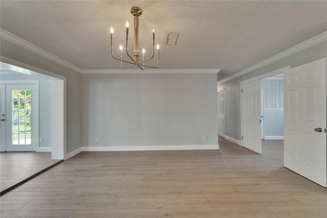4518 Helena St NE, Saint Petersburg, FL 33703 - unfurnished room with a chandelier, light wood-type flooring, a textured ceiling, and crown molding