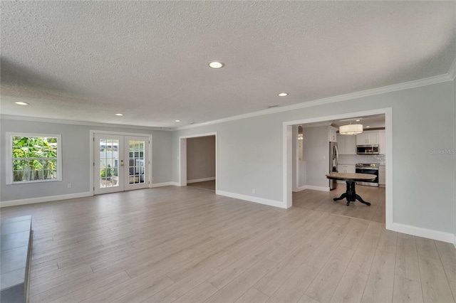 4518 Helena St NE, Saint Petersburg, FL 33703 - unfurnished living room with a textured ceiling, crown molding, french doors, recessed lighting, and light wood-style floors
