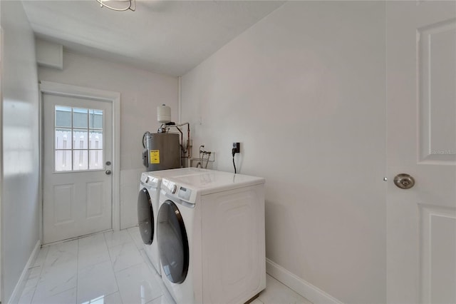 4518 Helena St NE, Saint Petersburg, FL 33703 - laundry area with electric water heater, washing machine and dryer, and light marble finish floors