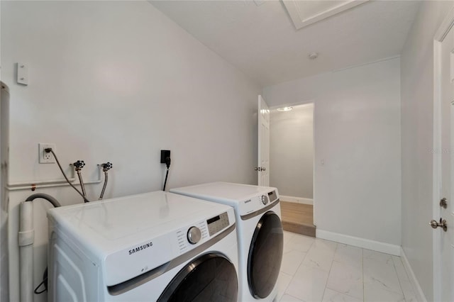 4518 Helena St NE, Saint Petersburg, FL 33703 - washroom with washing machine and dryer and light marble finish flooring