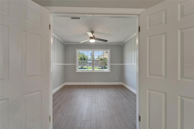 4518 Helena St NE, Saint Petersburg, FL 33703 - spare room featuring ceiling fan, wood finished floors, and crown molding
