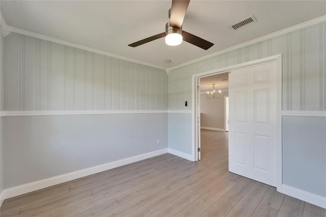 4518 Helena St NE, Saint Petersburg, FL 33703 - unfurnished room featuring a chandelier, ornamental molding, ceiling fan, and light wood finished floors