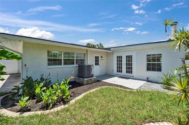 4518 Helena St NE, Saint Petersburg, FL 33703 - back of property featuring french doors and stucco siding