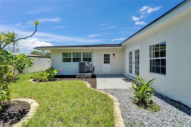 4518 Helena St NE, Saint Petersburg, FL 33703 - view of exterior entry with french doors, stucco siding, and a patio
