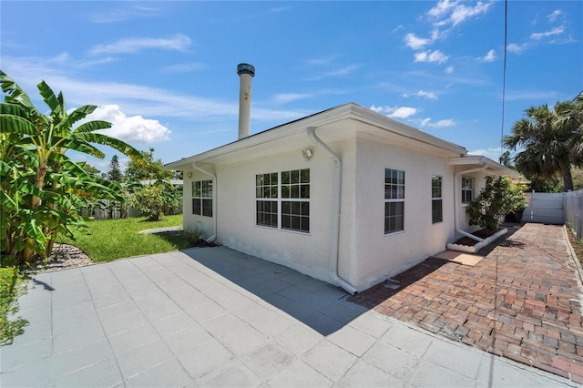 4518 Helena St NE, Saint Petersburg, FL 33703 - rear view of house with a patio and stucco siding