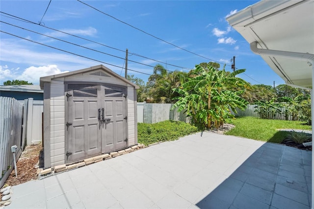 4518 Helena St NE, Saint Petersburg, FL 33703 - fenced backyard featuring a patio and a storage shed