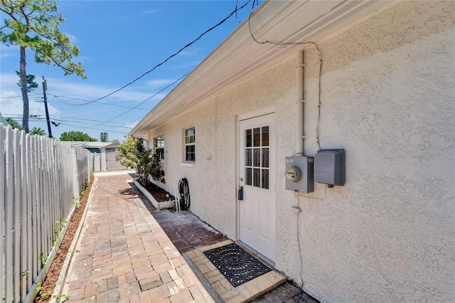 4518 Helena St NE, Saint Petersburg, FL 33703 - view of exterior entry featuring stucco siding and a patio