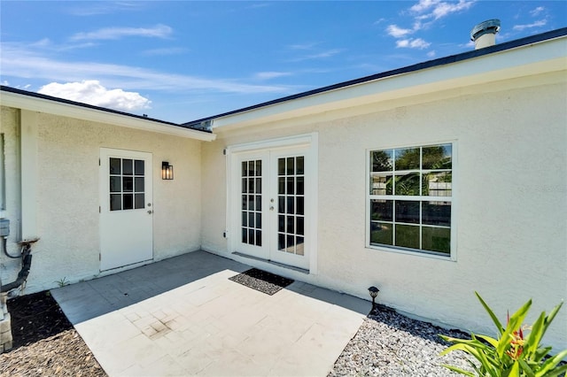 4518 Helena St NE, Saint Petersburg, FL 33703 - doorway to property featuring french doors, stucco siding, and a patio