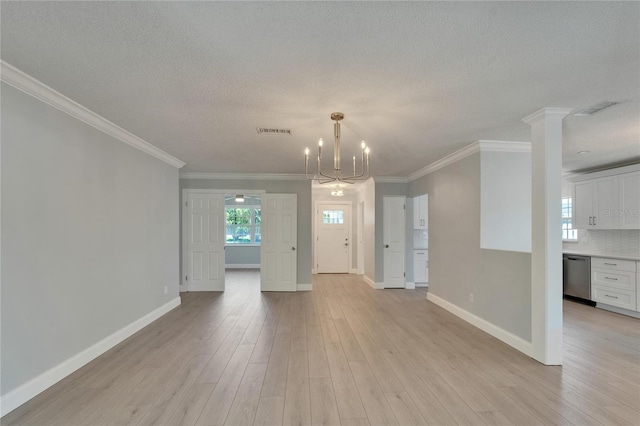 4518 Helena St NE, Saint Petersburg, FL 33703 - unfurnished living room with a textured ceiling, light wood finished floors, a chandelier, and crown molding