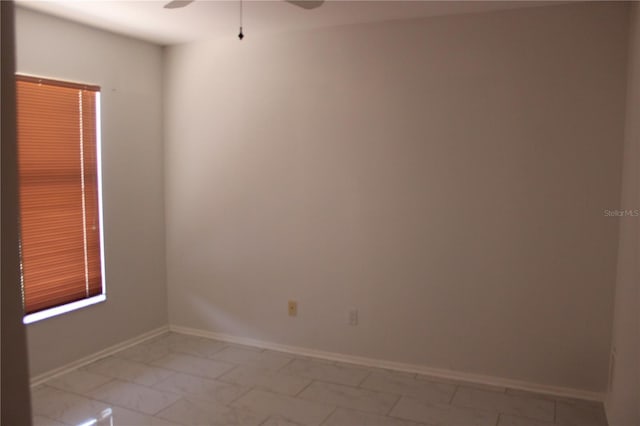 5581 Greyston St, Palm Harbor, FL 34685 - unfurnished room with a ceiling fan and light marble finish floors