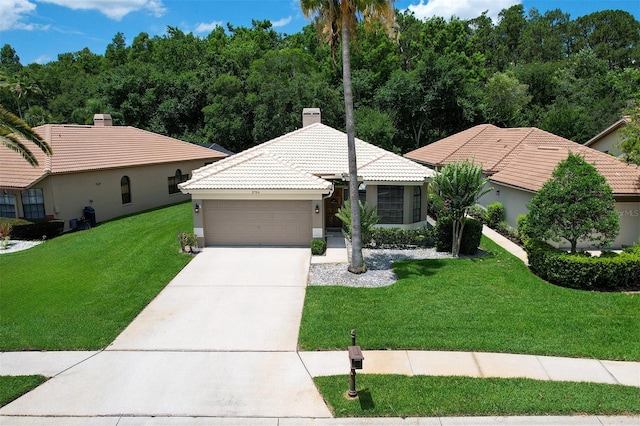 3704 Darston St, Palm Harbor, FL 34685 - ranch-style home with a tiled roof, a front lawn, an attached garage, concrete driveway, and stucco siding