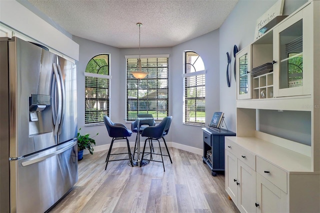 3704 Darston St, Palm Harbor, FL 34685 - dining space with a textured ceiling and light wood finished floors