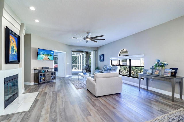 3704 Darston St, Palm Harbor, FL 34685 - living room featuring wood finished floors, ceiling fan, plenty of natural light, and recessed lighting