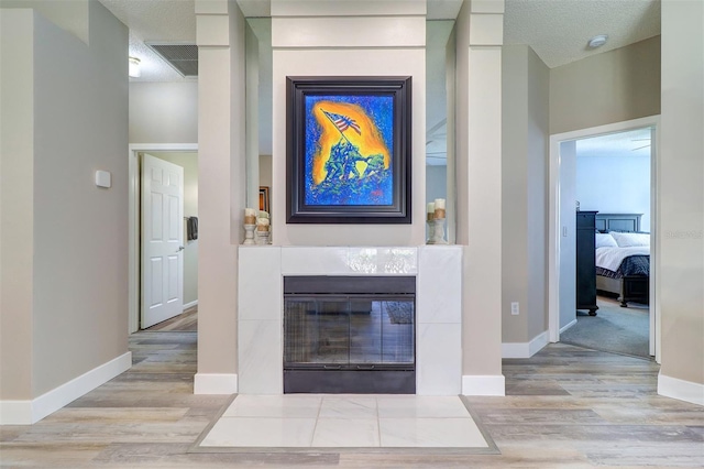 3704 Darston St, Palm Harbor, FL 34685 - living area featuring wood finished floors and a tiled fireplace