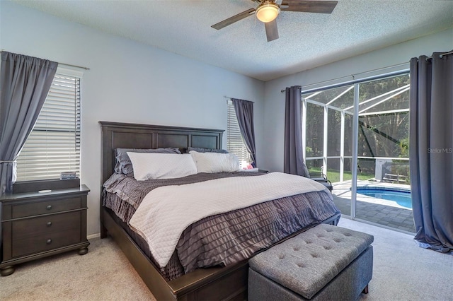3704 Darston St, Palm Harbor, FL 34685 - bedroom featuring light colored carpet, access to exterior, a textured ceiling, and ceiling fan