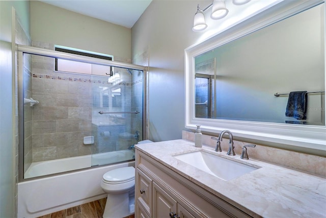 3704 Darston St, Palm Harbor, FL 34685 - bathroom with vanity, wood finished floors, and bath / shower combo with glass door
