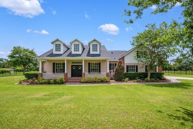 10510 Lithia Estates Dr, Lithia, FL 33547 - cape cod house featuring covered porch, stucco siding, and a shingled roof