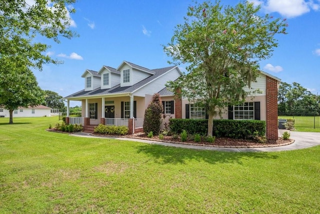 10510 Lithia Estates Dr, Lithia, FL 33547 - cape cod-style house with covered porch and brick siding