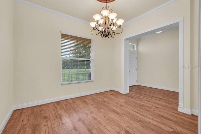 10510 Lithia Estates Dr, Lithia, FL 33547 - unfurnished room featuring ornamental molding, light wood-style floors, and a chandelier