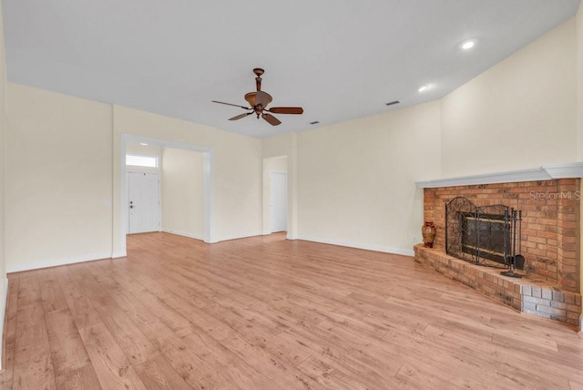 10510 Lithia Estates Dr, Lithia, FL 33547 - unfurnished living room featuring ceiling fan, light wood-type flooring, a brick fireplace, and recessed lighting