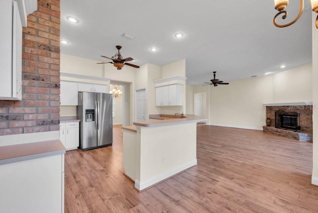 10510 Lithia Estates Dr, Lithia, FL 33547 - kitchen with stainless steel fridge with ice dispenser, a chandelier, ceiling fan, a fireplace, and open floor plan