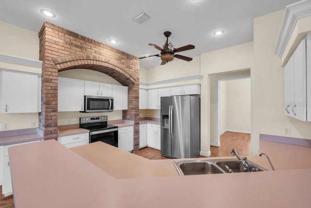 10510 Lithia Estates Dr, Lithia, FL 33547 - kitchen featuring stainless steel appliances, light wood-type flooring, ceiling fan, white cabinets, and recessed lighting