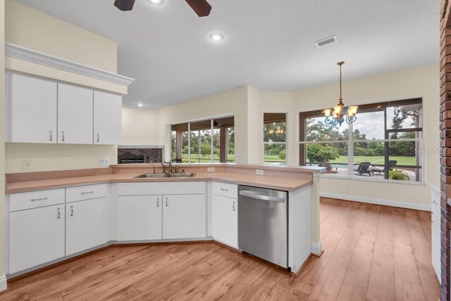 10510 Lithia Estates Dr, Lithia, FL 33547 - kitchen featuring stainless steel dishwasher, light countertops, recessed lighting, a chandelier, and white cabinets