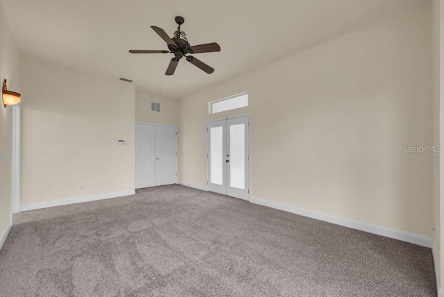 10510 Lithia Estates Dr, Lithia, FL 33547 - carpeted spare room featuring french doors, ceiling fan, and a high ceiling