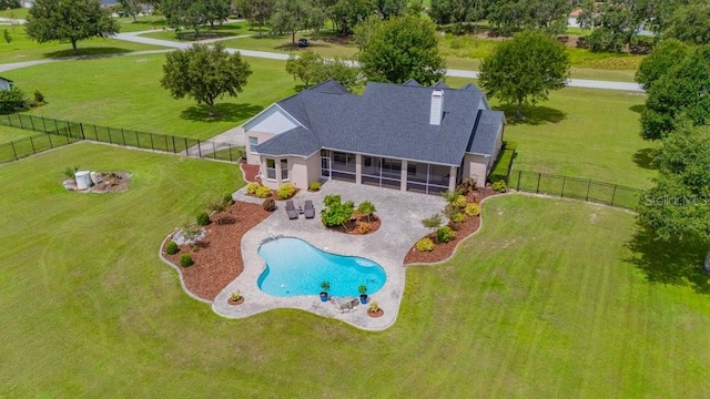 10510 Lithia Estates Dr, Lithia, FL 33547 - rear view of property with a sunroom, a patio, a fenced backyard, a chimney, and roof with shingles