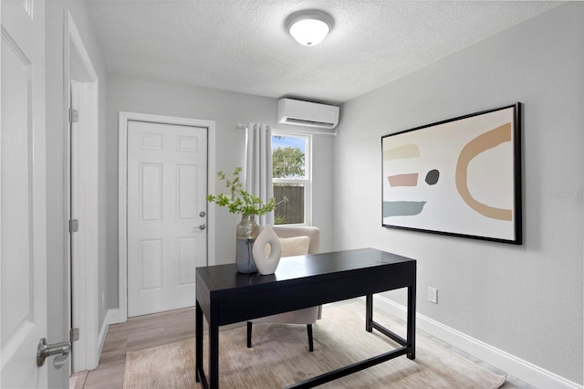 4300 Maple St NE, Saint Petersburg, FL 33703 - office with a textured ceiling, light wood-style flooring, and a wall mounted AC
