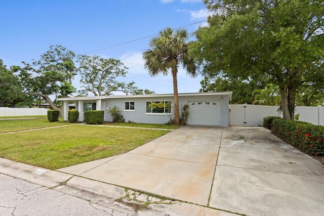 4300 Maple St NE, Saint Petersburg, FL 33703 - view of front of home with an attached garage, a gate, and concrete driveway