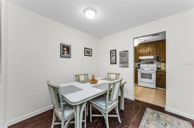 2700 Bayshore Blvd Unit 4106, Dunedin, FL 34698 - dining room featuring dark wood finished floors and baseboards