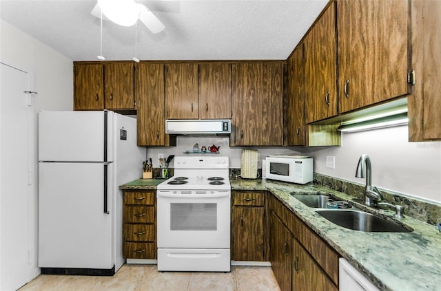 2700 Bayshore Blvd Unit 4106, Dunedin, FL 34698 - kitchen featuring white appliances, range hood, a ceiling fan, a textured ceiling, and light stone countertops