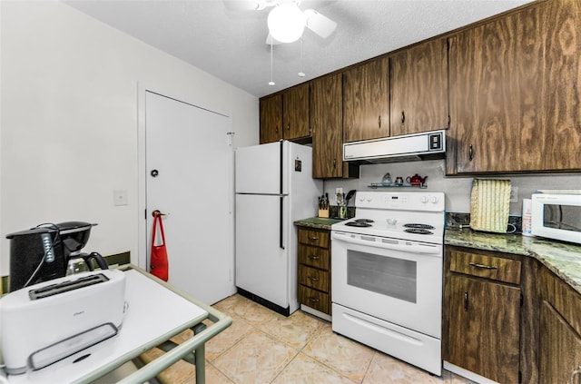 2700 Bayshore Blvd Unit 4106, Dunedin, FL 34698 - kitchen with range hood, white appliances, dark brown cabinetry, and a ceiling fan