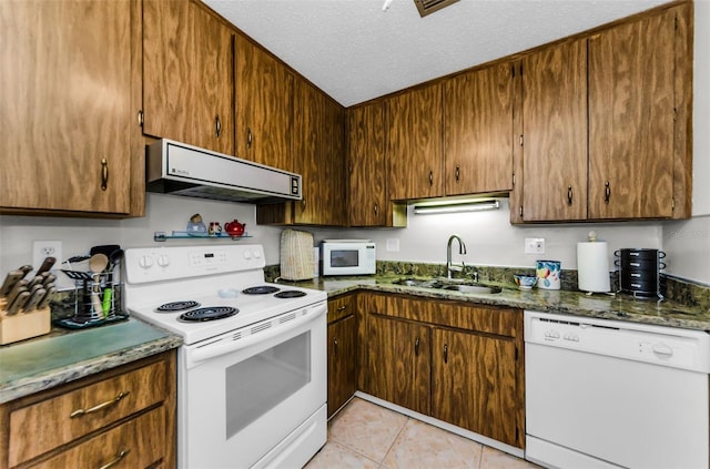 2700 Bayshore Blvd Unit 4106, Dunedin, FL 34698 - kitchen featuring white appliances, extractor fan, a textured ceiling, and light tile patterned flooring