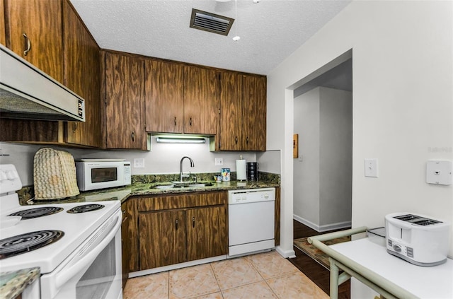 2700 Bayshore Blvd Unit 4106, Dunedin, FL 34698 - kitchen featuring white appliances, extractor fan, and a textured ceiling