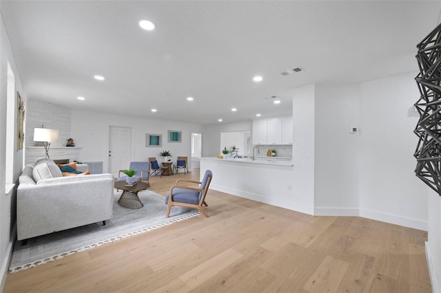 4753 58th St N, Kenneth City, FL 33709 - living area with light wood-type flooring, recessed lighting, and a fireplace