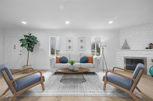 4753 58th St N, Kenneth City, FL 33709 - living area featuring light wood-style floors, recessed lighting, and a stone fireplace
