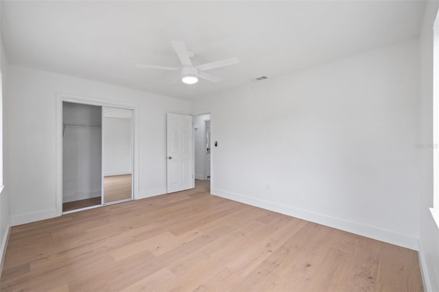 4753 58th St N, Kenneth City, FL 33709 - unfurnished bedroom with a closet, light wood-style floors, and a ceiling fan