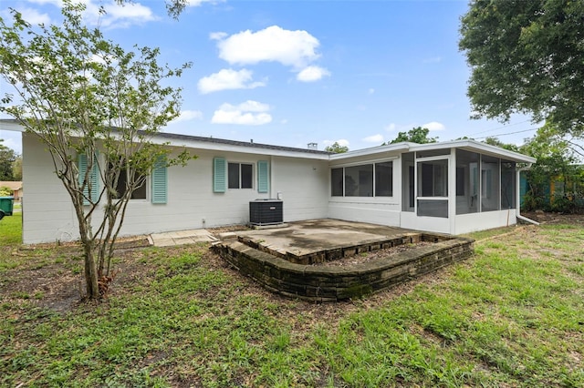 4753 58th St N, Kenneth City, FL 33709 - back of house featuring a sunroom, a patio area, and a yard