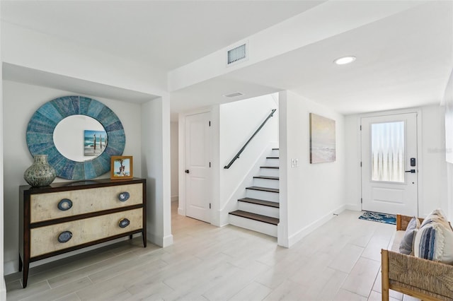 311 22nd St, Belleair Beach, FL 33786 - foyer entrance featuring stairway and light wood-style floors
