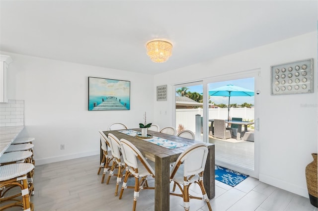 311 22nd St, Belleair Beach, FL 33786 - dining space featuring a chandelier and light wood-style floors