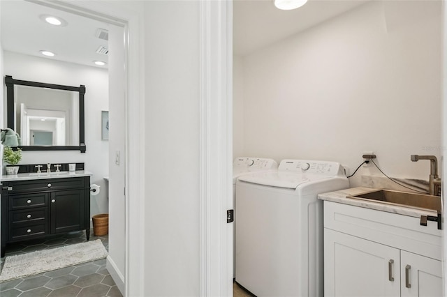 311 22nd St, Belleair Beach, FL 33786 - laundry area featuring washer / clothes dryer, dark tile patterned flooring, cabinet space, and recessed lighting
