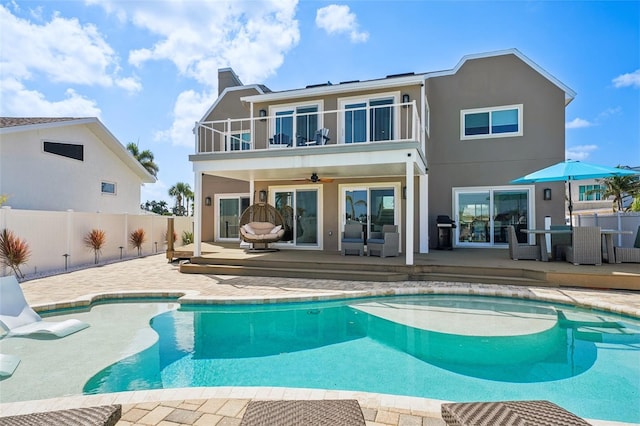 311 22nd St, Belleair Beach, FL 33786 - rear view of house with a balcony, ceiling fan, a patio, and stucco siding