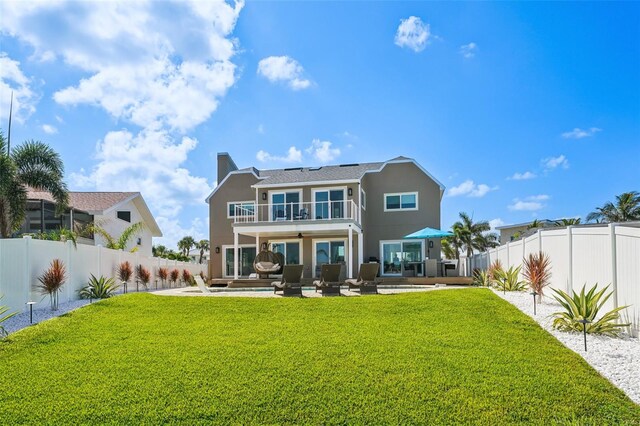 311 22nd St, Belleair Beach, FL 33786 - back of house with a balcony, an outdoor living space, ceiling fan, and a fenced backyard