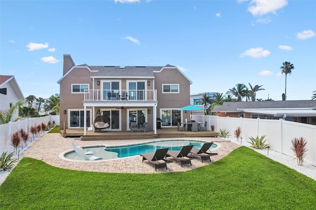 311 22nd St, Belleair Beach, FL 33786 - back of house featuring a balcony, a fenced backyard, stucco siding, a chimney, and a patio area