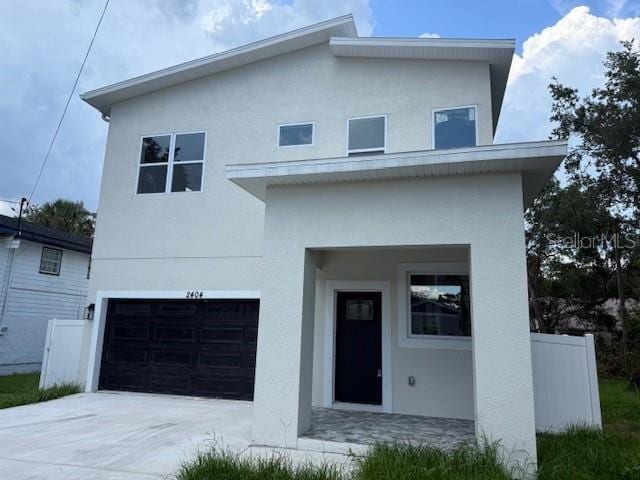 2404 Cassell St, Tampa, FL 33605 - view of front facade featuring an attached garage, stucco siding, and driveway